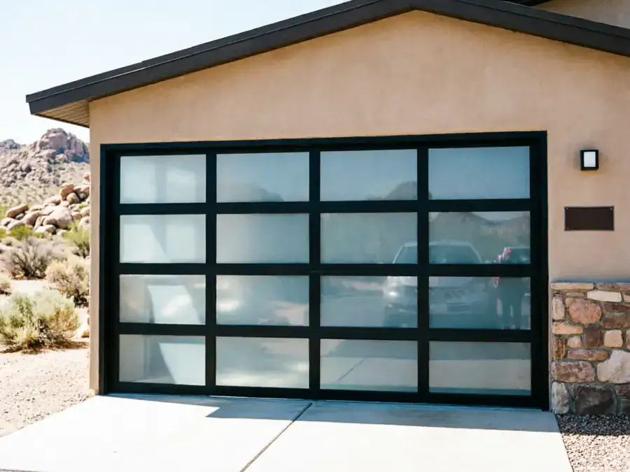 A modern garage door with frosted glass panels on a stucco house.